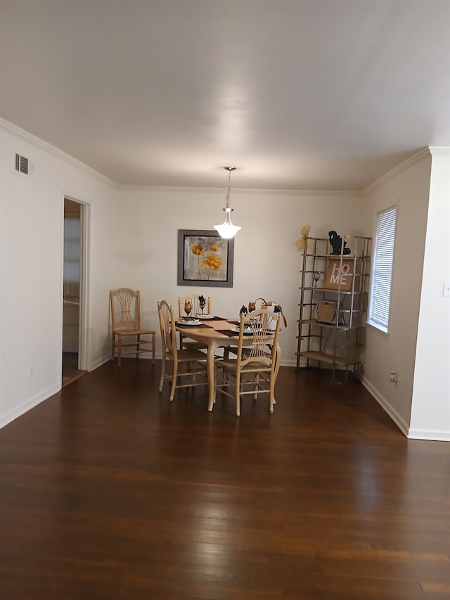 dining space featuring crown molding and dark hardwood / wood-style floors