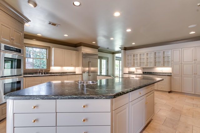 kitchen featuring a large island, appliances with stainless steel finishes, and white cabinetry