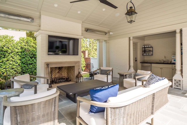 view of patio with an outdoor living space with a fireplace