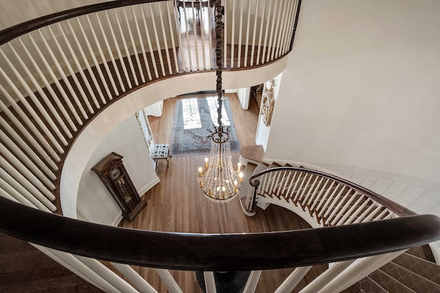 staircase featuring a notable chandelier