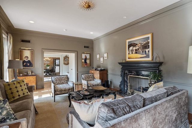 living room with ornamental molding and a premium fireplace