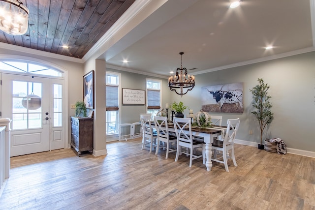 dining room with ornamental molding, a chandelier, and light wood-type flooring