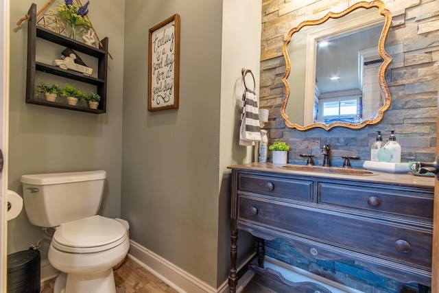 bathroom with vanity, decorative backsplash, toilet, and wood-type flooring