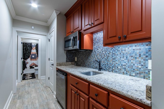 kitchen with light hardwood / wood-style flooring, stainless steel appliances, ornamental molding, sink, and light stone counters