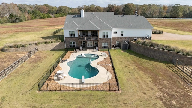 view of pool with a yard, a diving board, and a patio