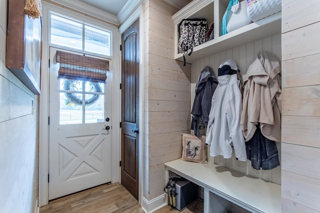 mudroom featuring light hardwood / wood-style floors and wood walls