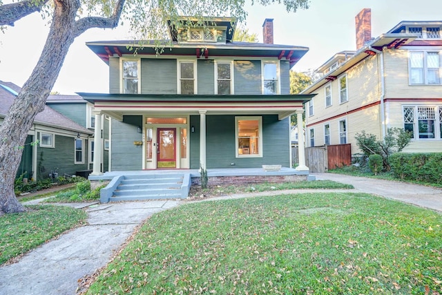 view of front facade featuring a front lawn and covered porch