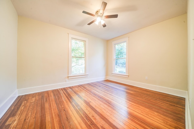 empty room with ceiling fan and wood-type flooring