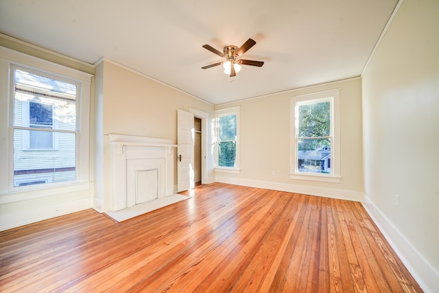 interior space with crown molding, light wood-type flooring, and ceiling fan