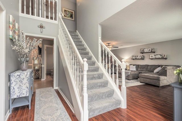 stairway featuring hardwood / wood-style floors and a textured ceiling