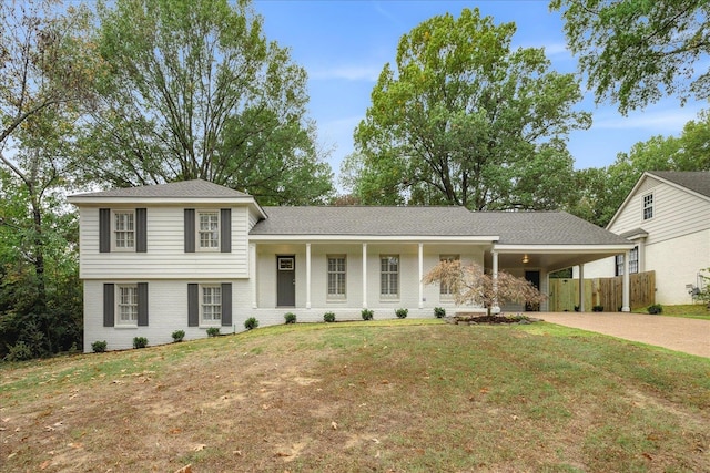 tri-level home featuring a carport and a front yard