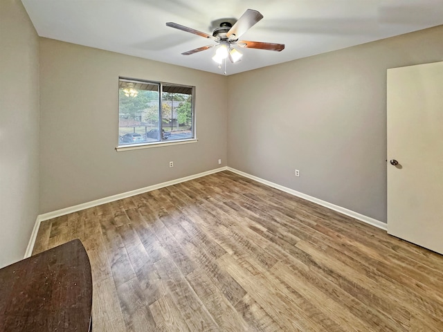 spare room with ceiling fan and wood-type flooring