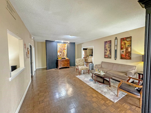 living room featuring parquet flooring and a textured ceiling