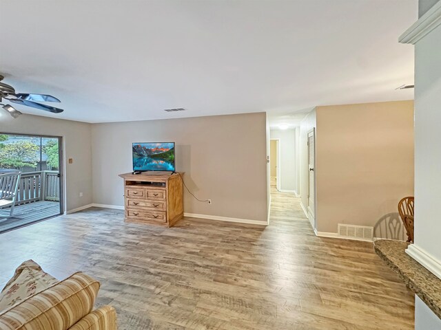 living room featuring hardwood / wood-style floors and ceiling fan