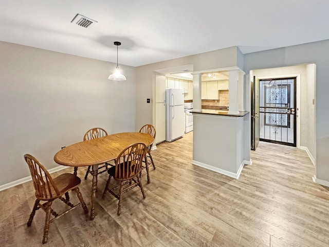 dining space with light wood-type flooring