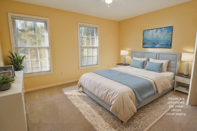 bedroom featuring multiple windows, light colored carpet, and ceiling fan