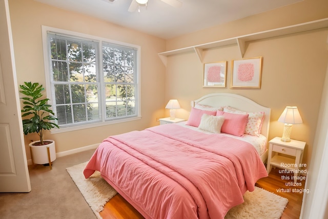 bedroom with light hardwood / wood-style flooring and ceiling fan