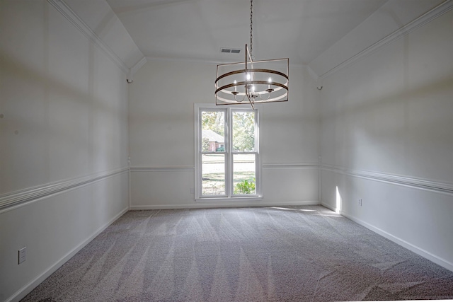 spare room featuring lofted ceiling, a notable chandelier, and carpet flooring