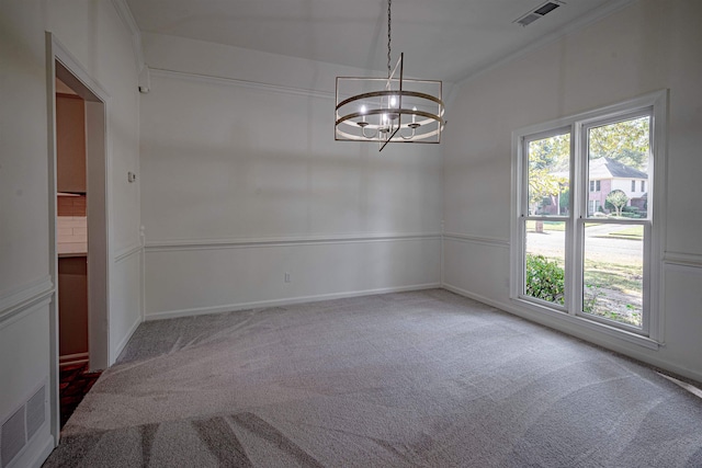 carpeted empty room featuring an inviting chandelier and crown molding