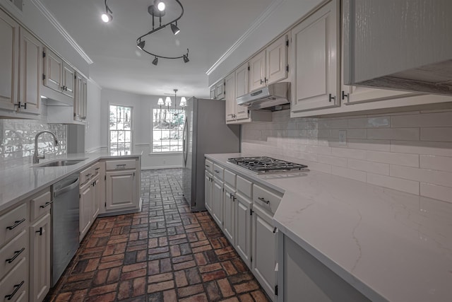 kitchen with appliances with stainless steel finishes, decorative backsplash, white cabinetry, and sink