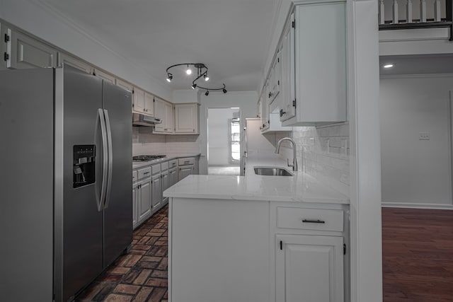 kitchen featuring decorative backsplash, stainless steel appliances, crown molding, sink, and white cabinets