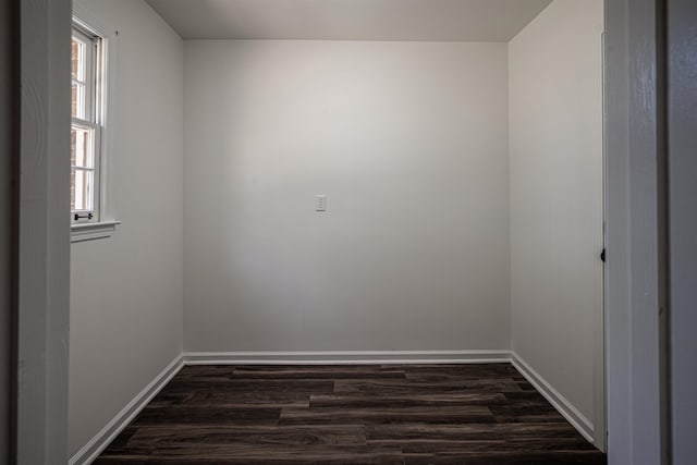 unfurnished room with dark hardwood / wood-style flooring