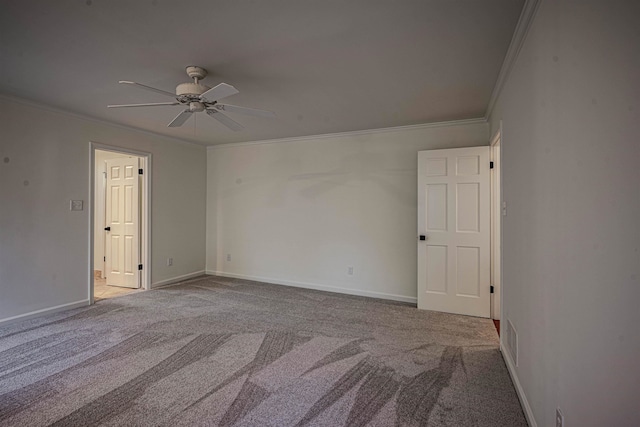 spare room with crown molding, carpet floors, and ceiling fan