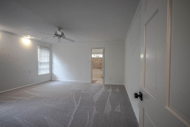 spare room featuring ceiling fan, carpet flooring, and ornamental molding