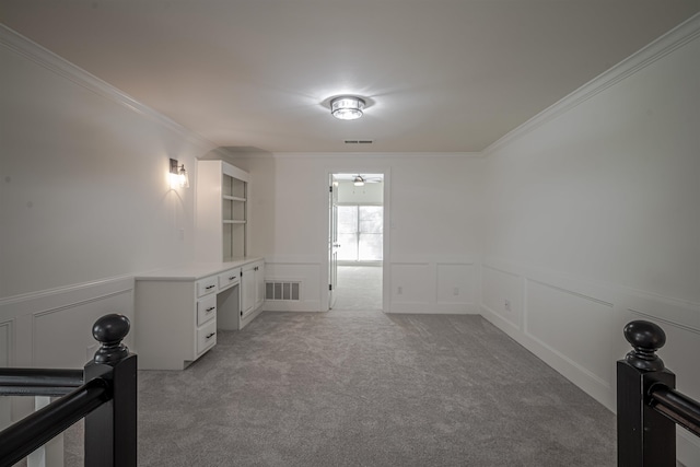 carpeted empty room featuring ornamental molding