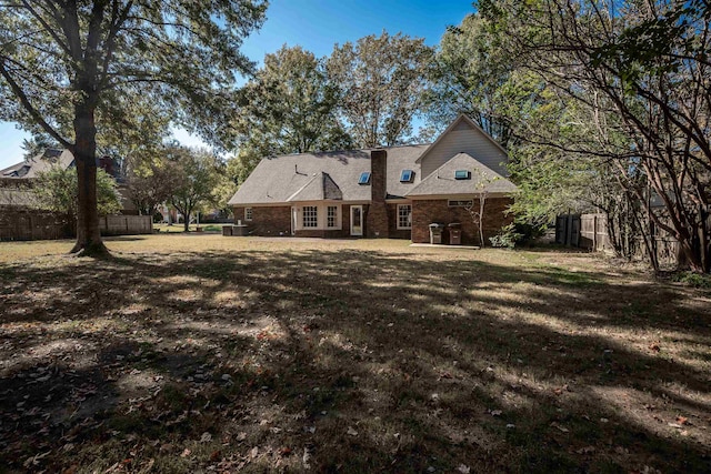 back of property with a patio and a lawn