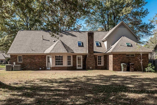 view of front facade with a patio, a front yard, and cooling unit