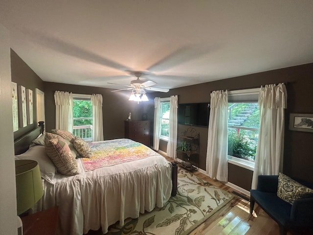 bedroom featuring hardwood / wood-style flooring and ceiling fan