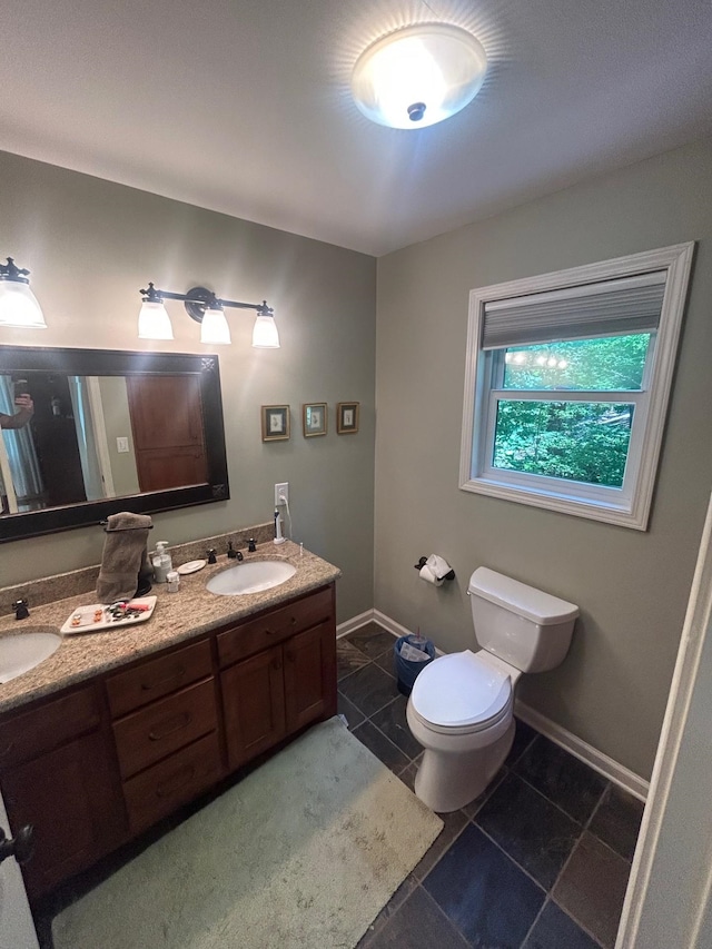 bathroom with vanity, toilet, and tile patterned floors