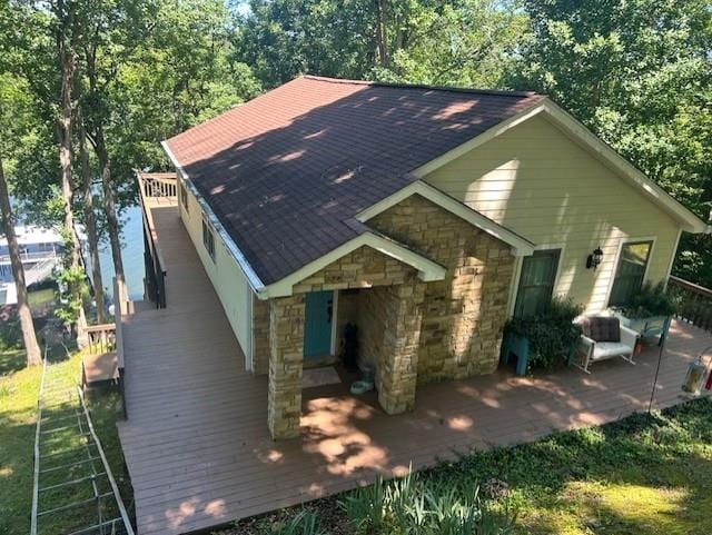 rear view of property featuring a deck