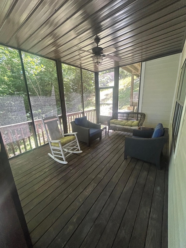 unfurnished sunroom featuring ceiling fan