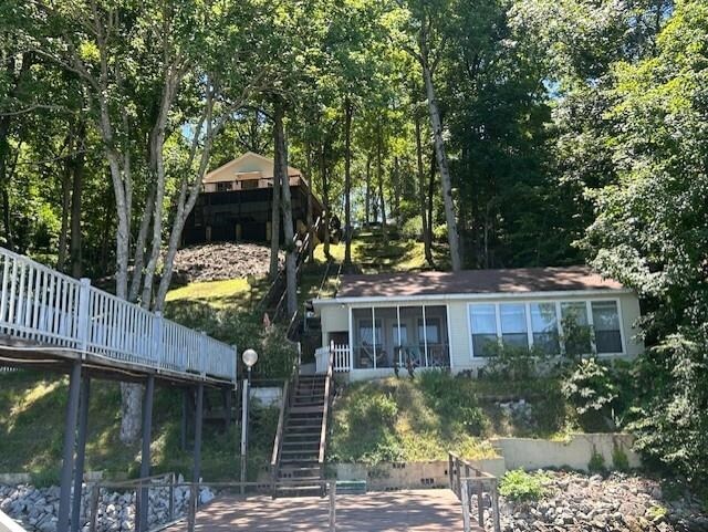 back of property with a sunroom