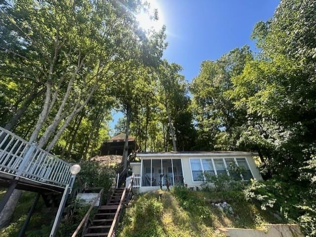 rear view of house featuring a sunroom