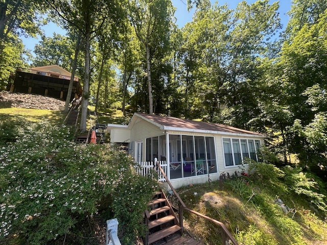 back of house featuring a sunroom