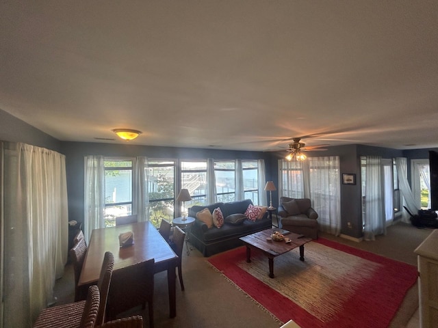 living room featuring a water view and ceiling fan