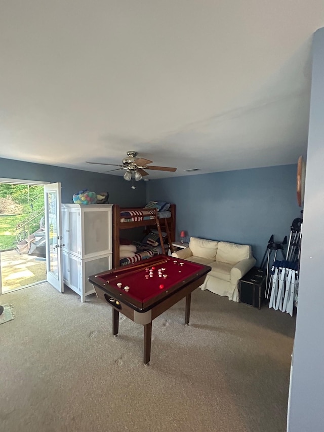 game room with ceiling fan and carpet