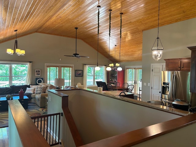 kitchen with wood ceiling, stainless steel fridge with ice dispenser, high vaulted ceiling, ceiling fan with notable chandelier, and decorative light fixtures