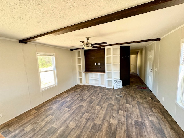 unfurnished room featuring dark hardwood / wood-style flooring, a textured ceiling, crown molding, and beam ceiling