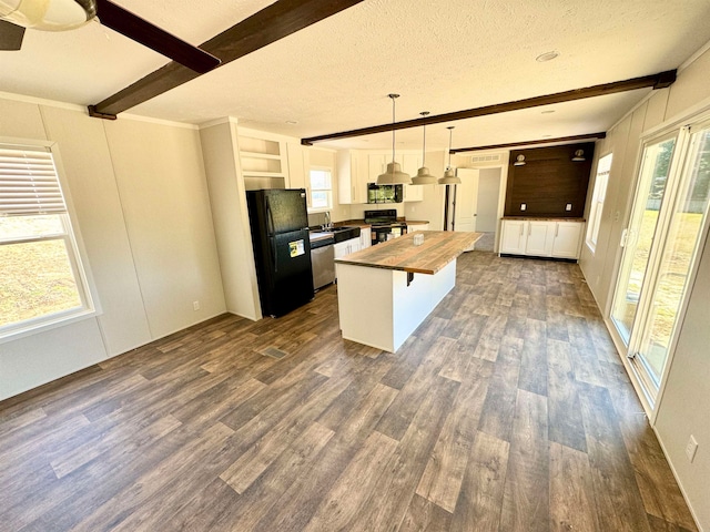 kitchen with pendant lighting, a textured ceiling, black appliances, and dark hardwood / wood-style floors