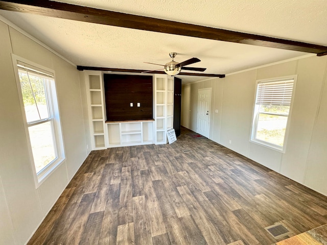 unfurnished living room featuring ornamental molding, a textured ceiling, dark hardwood / wood-style flooring, beamed ceiling, and ceiling fan