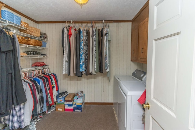 laundry area with crown molding, a textured ceiling, and separate washer and dryer