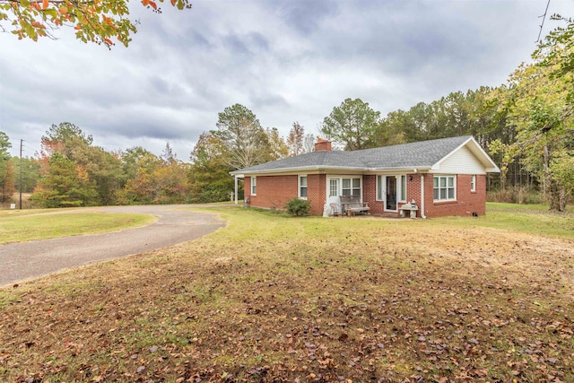 ranch-style home with a front lawn