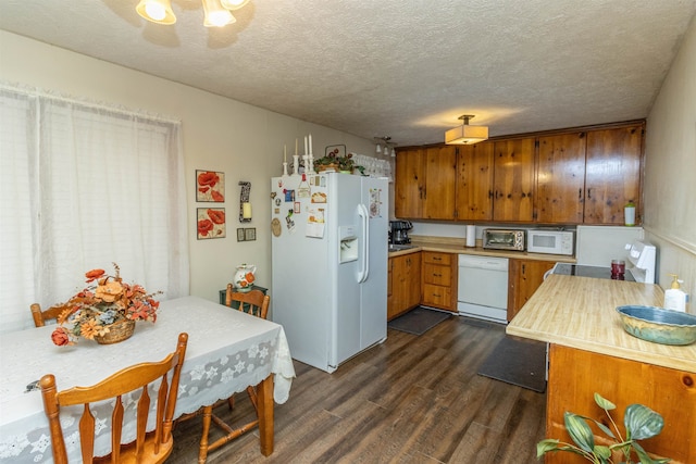 kitchen featuring a textured ceiling, dark hardwood / wood-style floors, and white appliances