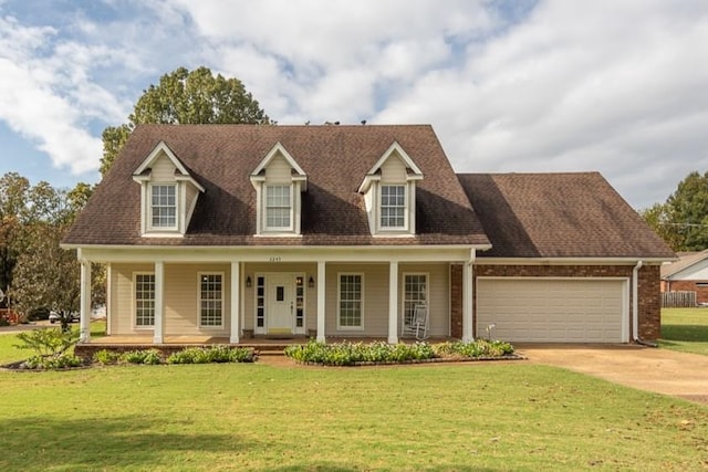 cape cod home with covered porch, a front yard, and a garage