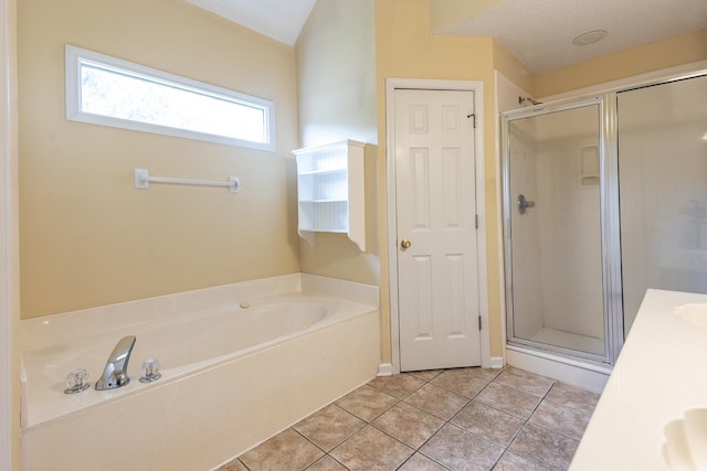 bathroom featuring vanity, separate shower and tub, a textured ceiling, and tile patterned floors