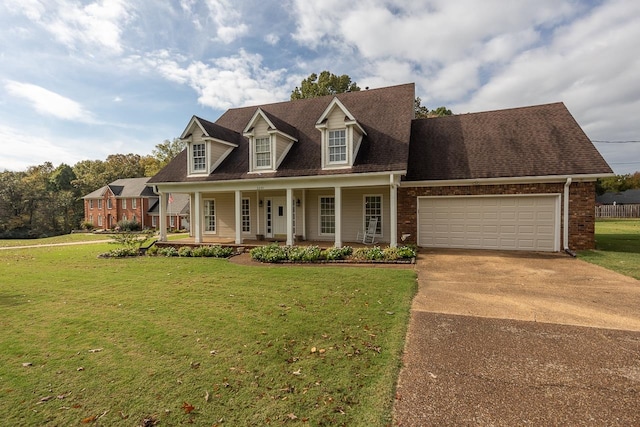 cape cod house featuring a porch, a front yard, and a garage